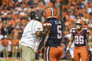 Dino Babers speaks with tight end Chris Elmore, who didn't record a reception in the game.