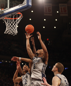 Georgetown's Mikael Hopkins (#3) attempts a defensive rebound.