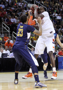 Baye Moussa-Keita #12 holds on to the ball against Allen Crabbe #23 of the California Golden Bears.