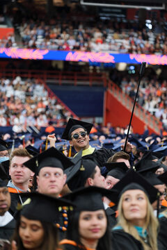 Students pose for photo-ops before the ceremony proceedings begin. One student brought a 360-degree camera to capture commencement from every angle. 