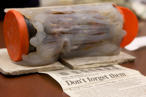 Ed Galvin, director of the Syracuse University Archives, displays a time capsule discovered during the renovation of the Remembrance Wall. The capsule was placed in the wall during its construction in 1990, unbeknownst to University officials. This year a new time capsule will be buried near the wall commemorating the Pan Am Flight 103 victims.