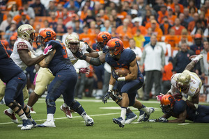 Running back George Morris II takes a carry during Tim Lester's debut as SU's offensive coordinator. The Orange scored its first offensive touchdown since Sept. 27.