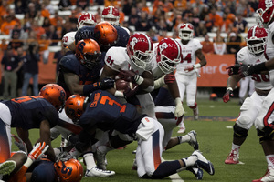 The Syracuse defense, including safety Durell Eskridge, converges to bring down N.C. State running back Matt Dayes.