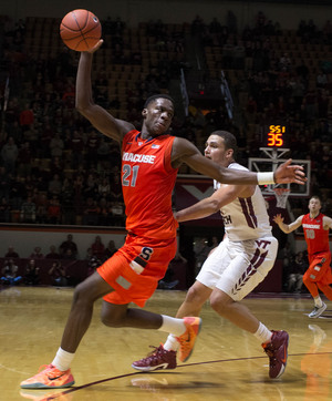 SU forward Tyler Roberson grabs a long offensive rebound near the perimeter. The sophomore recorded his third career double-double by snatching 17 rebounds to go with his 11 points.