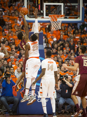 Syracuse senior Rakeem Christmas attempts to deny a Florida State player's drive to the rim during the Orange's win Sunday night.