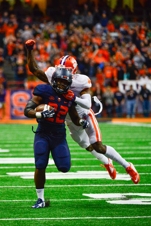 Syracuse running back Jordan Fredericks is chased down by a Clemson defender in the Orange's 37-27 loss on Saturday. 