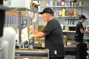 Employees prepare food in the Good Uncle Kitchen, using the same ovens and fryers found in the New York City restaurants that have licensed their items to the tech startup.