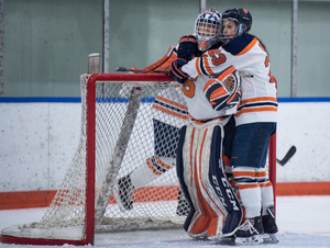 Megan Quinn hugs goalkeeper Abbey Miller after a 3-0 win over Penn State on Nov. 10. The Orange has halted its nonconference skid and has not lost in College Hockey America. 