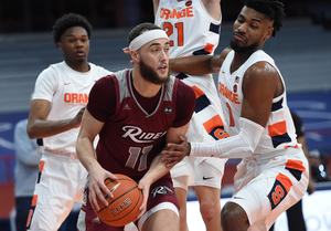 Quincy Guerrier defends against Rider forward Tyrel Bladen. The Orange held the Broncs to 52 points in SU's blowout win. 