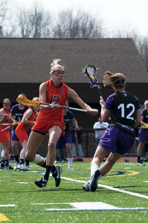 Christina Dove (left) and the SU womens lacrosse team played on three separate home turfs last week. Syracuse was happy to return to the Carrier Dome Sunday.