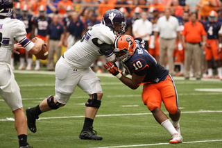 Syracuse defensive end, Markus Pierce-Brewster tries to get to Northwestern quarterback Kain Colter.