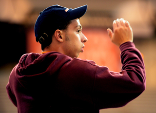 Jason Kammere, an SU junior and marching band drum major, keeps time with his fellow drum majors.