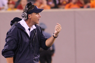 Syracuse head coach Doug Marrone calls a player over to the sideline.