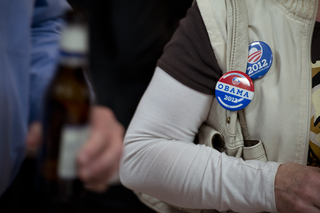 An Obama supporter expresses her allegiance to the incumbent president through purse accessories. 