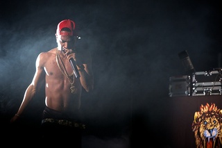 Big Sean emerges out of a cloud of smoke during his performance.