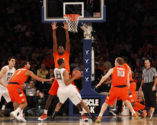 Baye Moussa Keita puts his arms up as he defends the paint from Trey Ziegler.