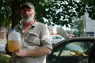 Ray Kemble holds a jug of contaminated well water from his home in Dimock, Pa. 