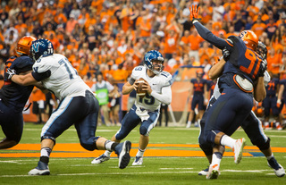 Villanova quarterback John Robertson keeps his eyes downfield as the Syracuse defensive line applies pressure.