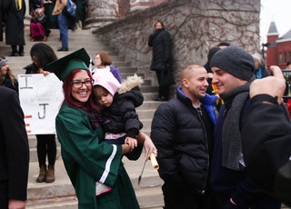 Emily Benazzi, a class of 2014 environmental education and interpretation graduate, poses with her niece, Bella Benazzi, outside of Hendricks Chapel. The SUNY-ESF graduation ceremony time coincided with the time of the rally.