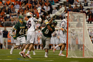 Ryan Simmons pressures Siena from the side of the goal as the Saints' Nick Capalbo tries to make a save. Simmons scored two goals for SU in the Orange's 21-7 win.