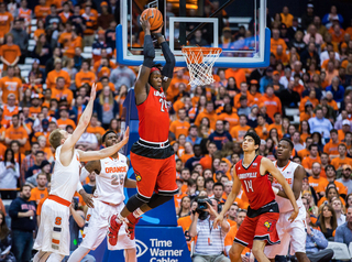 Harrell controls the ball in the airb while being pressured by Cooney.