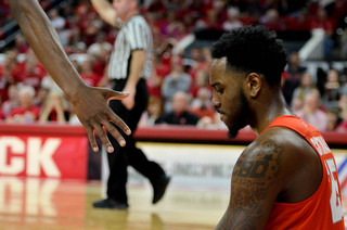 Christmas sits on the ground as a teammates' hand offers to help him up.