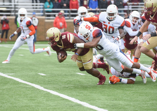 A Syracuse defender drags down Boston College's Davon Jones (16).