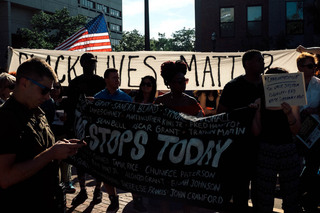 Members of Black Lives Matter Syracuse held up several banners, one listing the names of all the people who have died as a result of police violence and another carrying the group's name and motto, during Sunday's rally. 