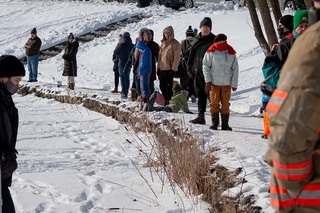 Spectators gather around the outskirts of the lake to watch their favorite hockey teams in single digit temperatures. 